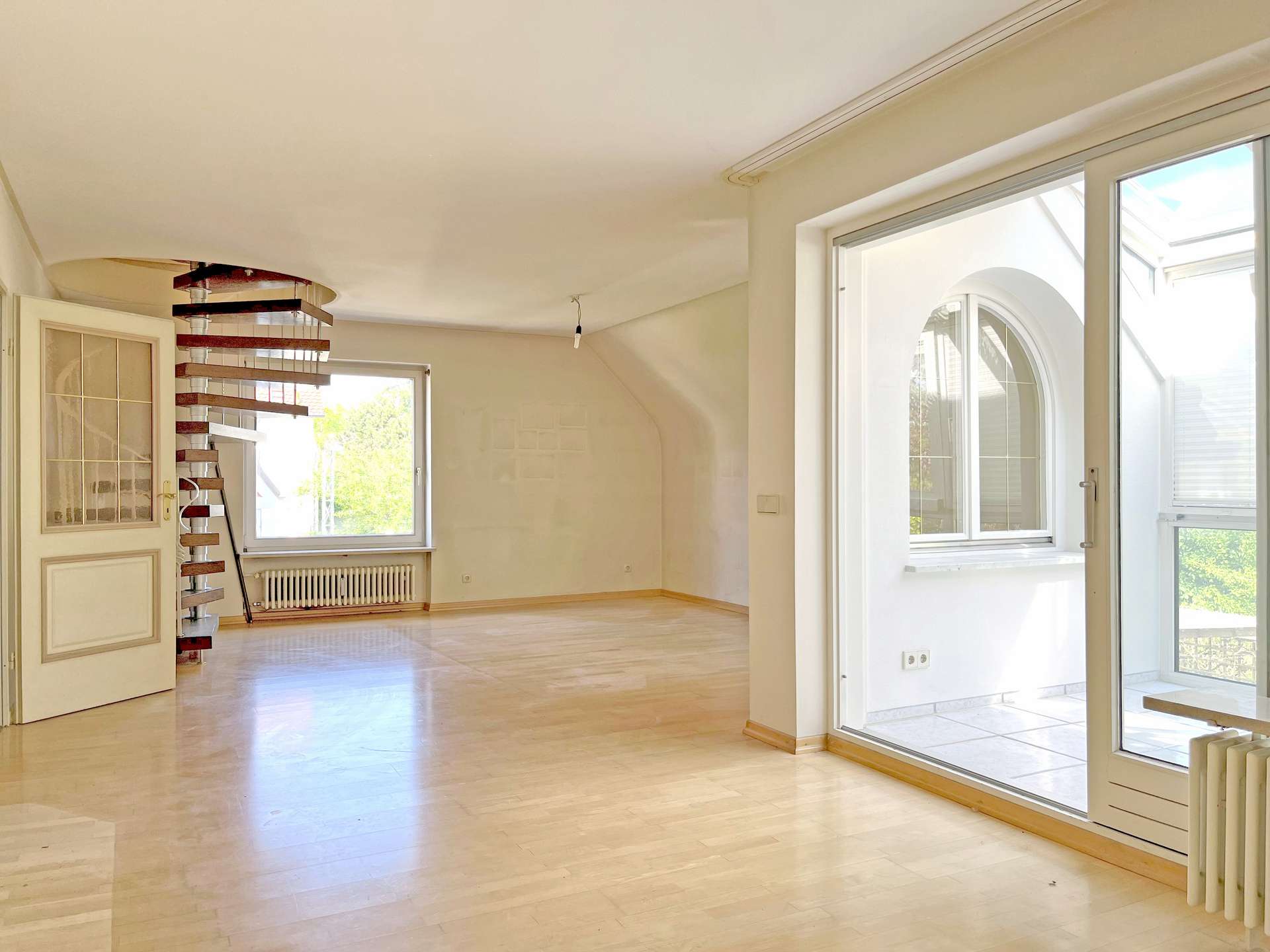 Helles Wohnzimmer mit Wendeltreppe nach oben