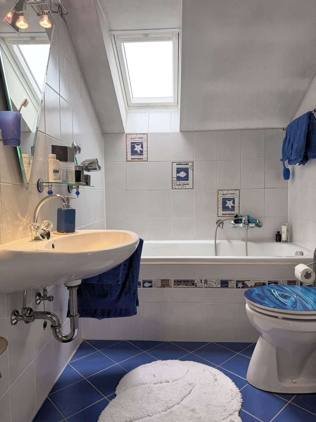 Gefliestes Badezimmer mit Dachfenster